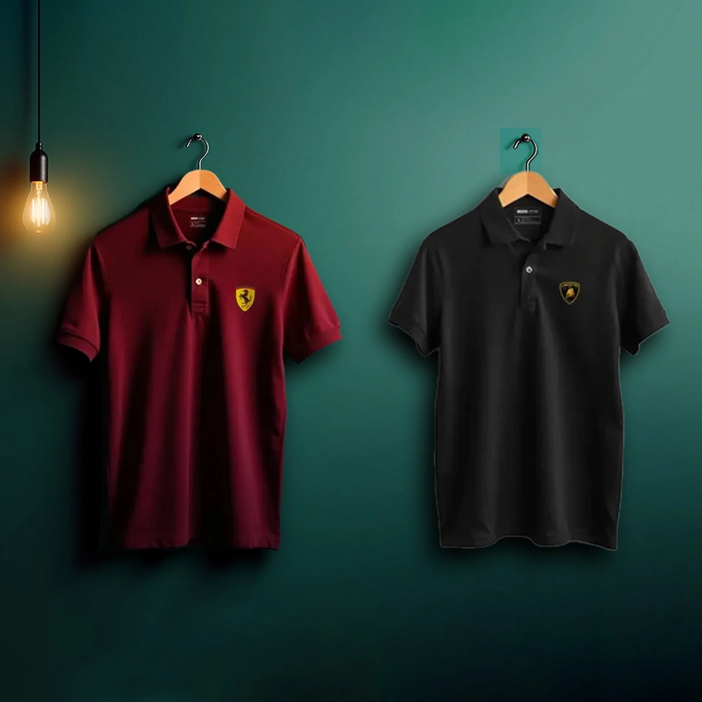 Two polo shirts, one maroon and one black, with a logo on a green wall.