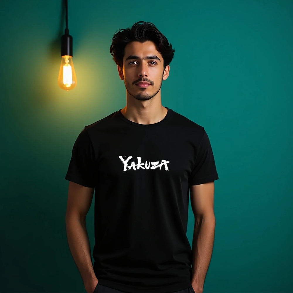 Man wearing a black t-shirt with 'Yakuza' logo against a teal background with a light bulb.