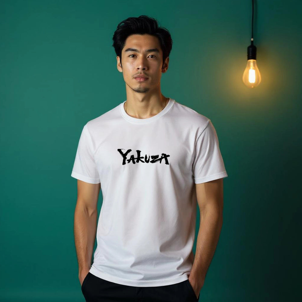 Man wearing a white t-shirt with 'Yakuza' logo against a teal background with a light bulb.