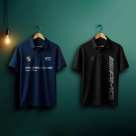 Two polo shirts, one with Porsche logo and text, the other with AMG logo, on wooden hangers against a green wall.