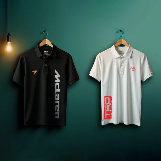 Black and white polo shirts with McLaren and Toyota logos on hangers against a green wall.